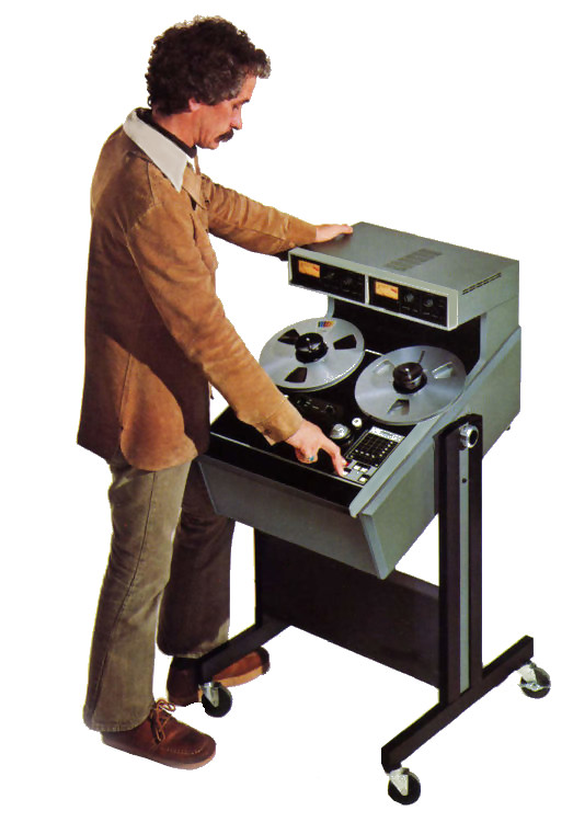 An audio engineer uses a large studio reel to reel recorder